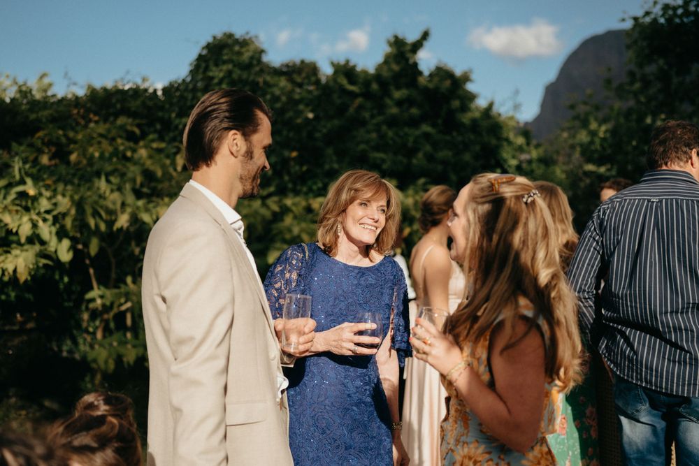 Wedding guests mingling and chatting during an outdoor celebration.