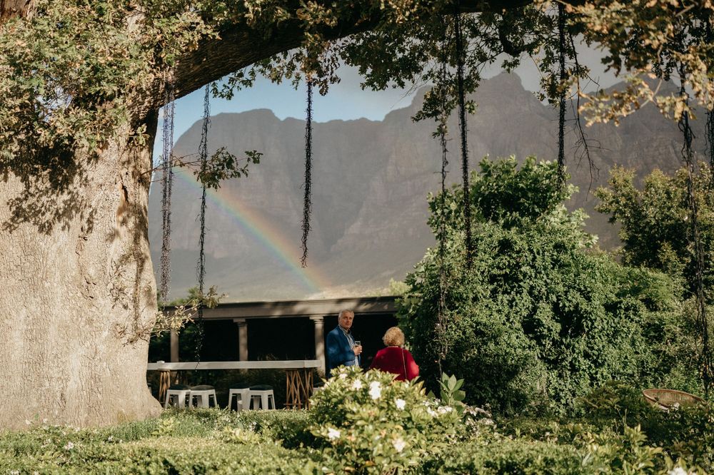 A scenic outdoor venue with mountains visible through hanging decorative elements.