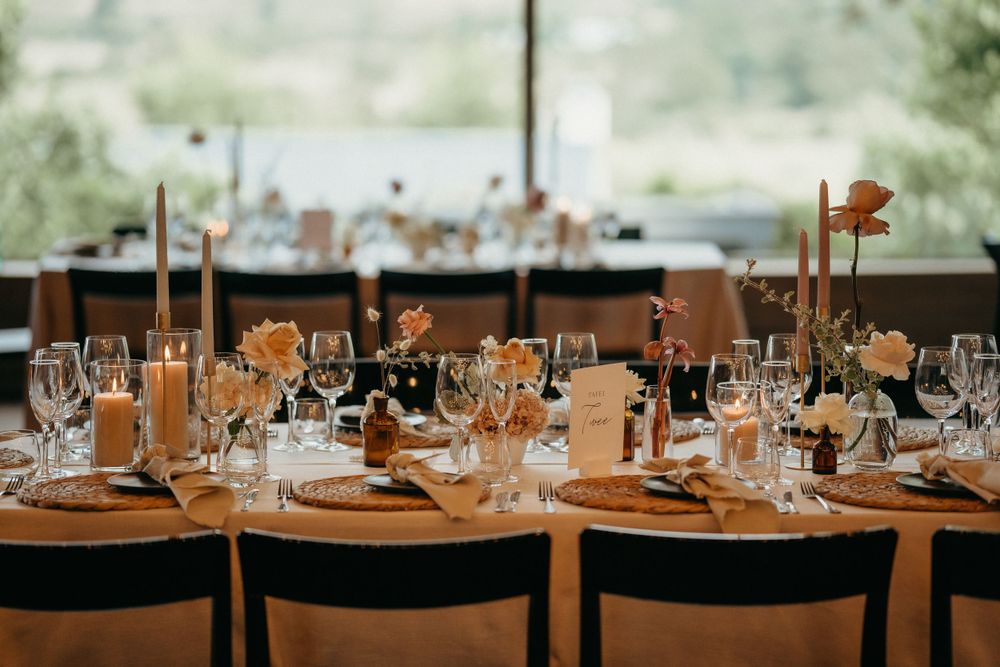 Elegant wedding reception table setting with wine glasses and place settings.
