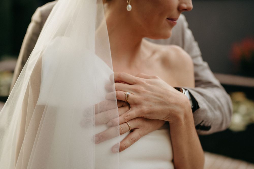 Close-up detail of a bride's veil and elegant white wedding dress.