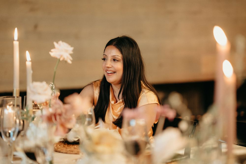 A guest enjoying the ambiance of an elegant candlelit wedding reception dinner.