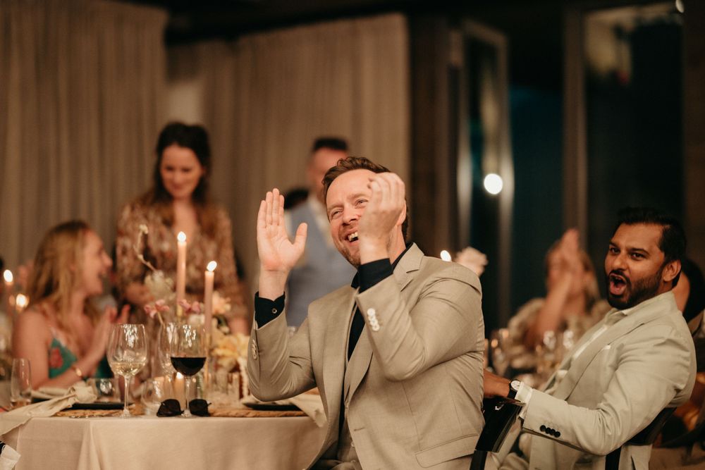 Wedding reception dinner scene with guests dining and celebrating.