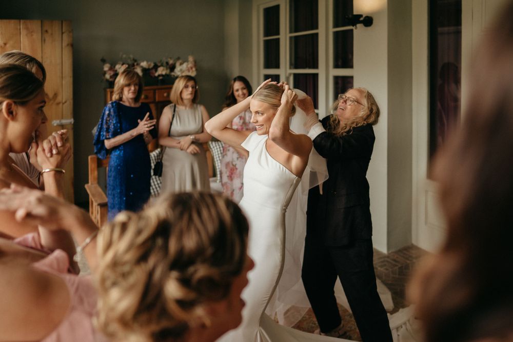 Wedding party dances and celebrates together during a joyful reception moment.