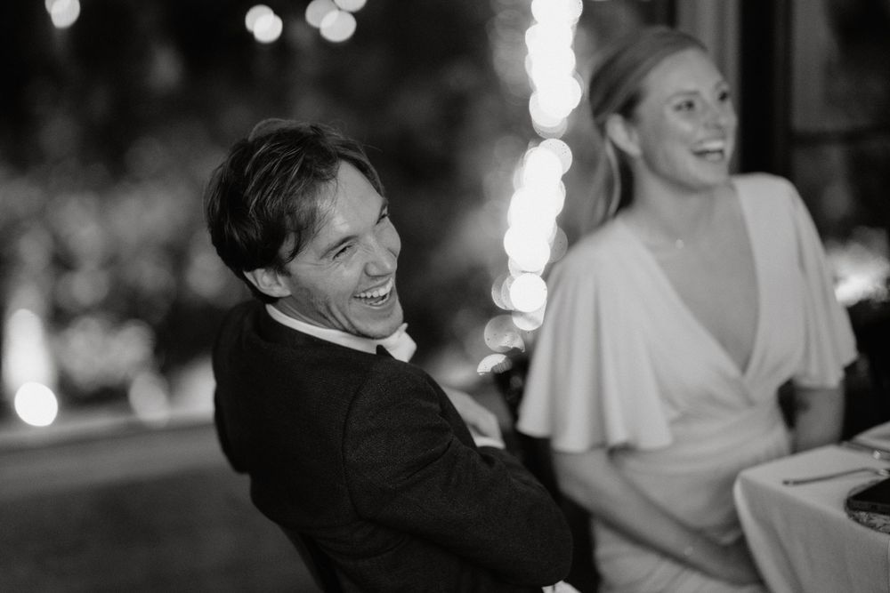 Black and white candid photo of celebration with sparklers creating a festive atmosphere.