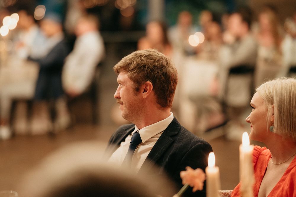 Wedding guests watching entertainment during evening reception.