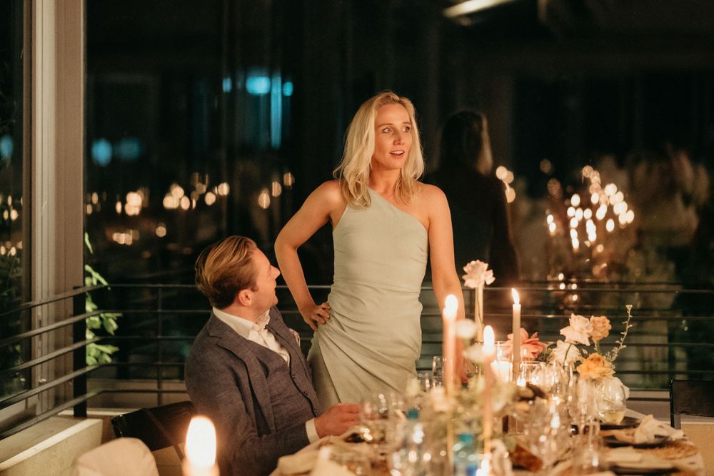 Romantic proposal moment captured during candlelit dinner setting.
