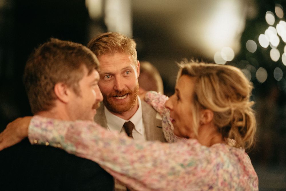 Wedding guests share an intimate moment during evening celebrations.