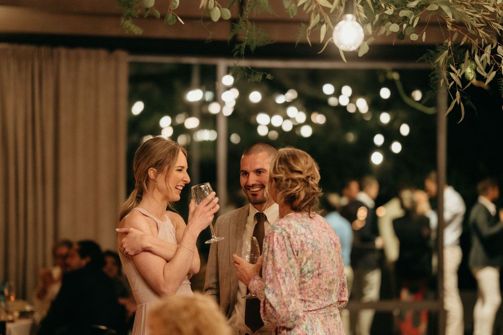 Guests enjoy conversations during an intimate wedding reception with ambient lighting and décor.