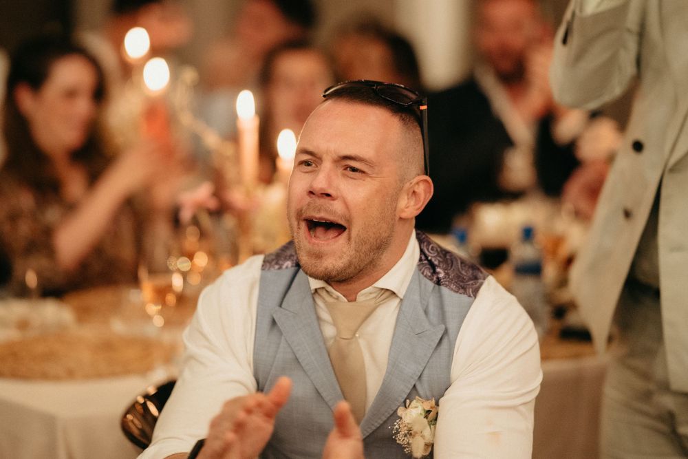 Wedding guest showing excitement during an emotional moment at the reception.