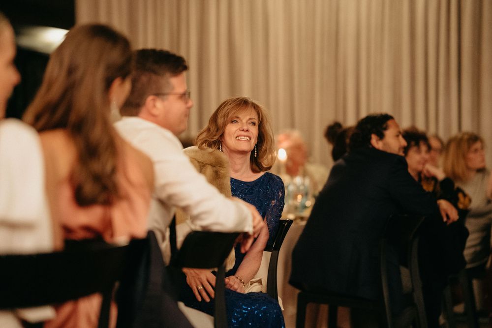 Wedding reception guests dancing and celebrating on the dance floor.