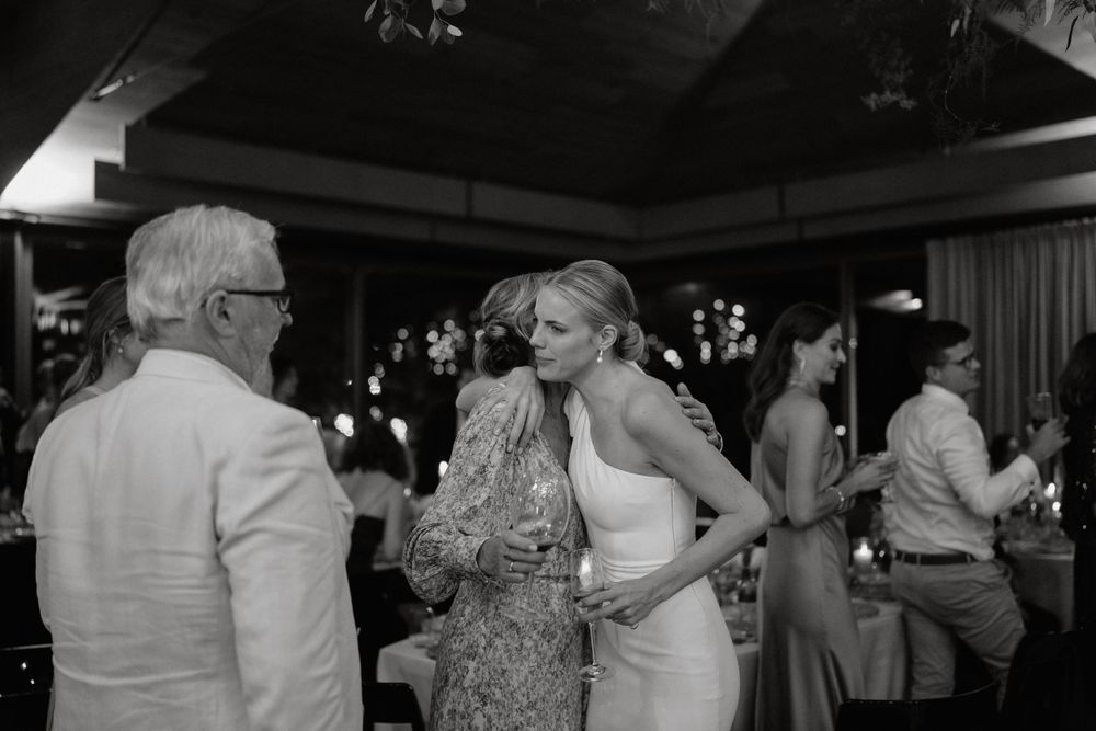 Wedding reception guests socializing and dancing at an evening celebration.