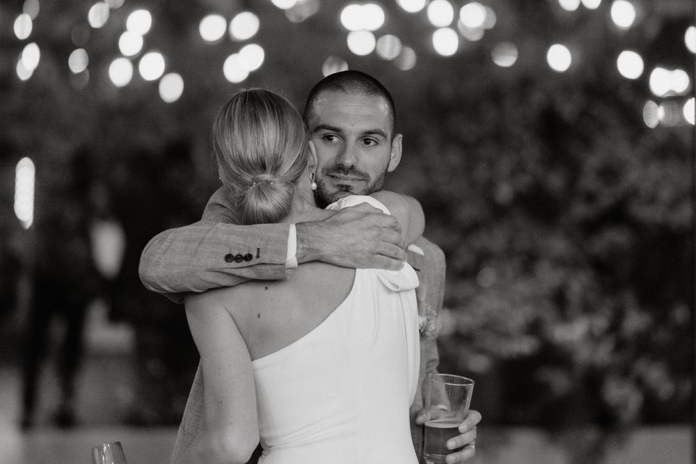 A black and white capture of an intimate dance moment at a wedding reception.