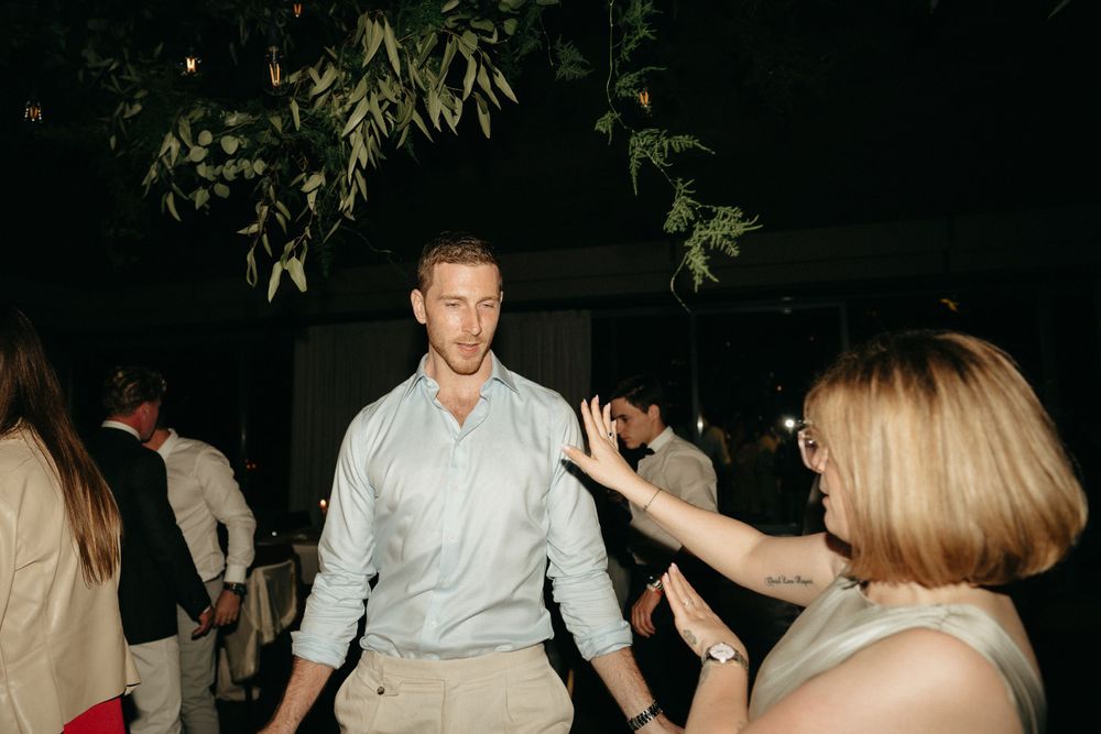 Wedding reception dance floor scene with guests enjoying the celebration.