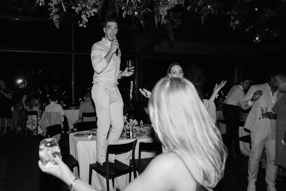 Party guests enjoying a lively celebration with entertainment in black and white photography.