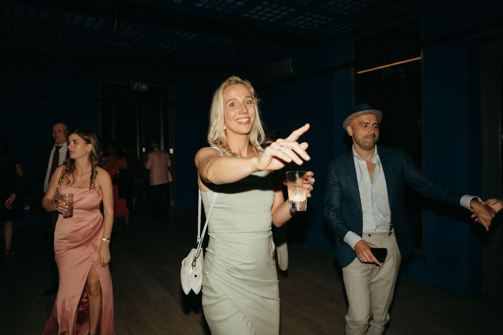 Wedding guests dancing and having fun at an evening reception party.