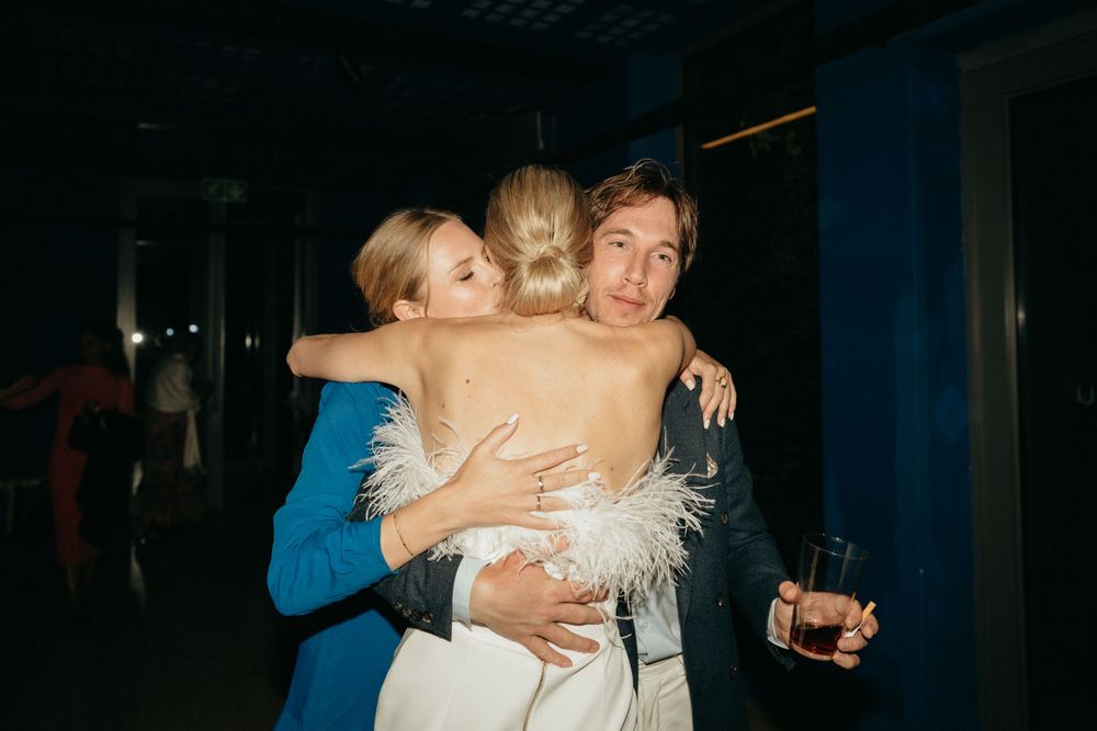 Friends sharing an emotional group hug during a celebratory moment.