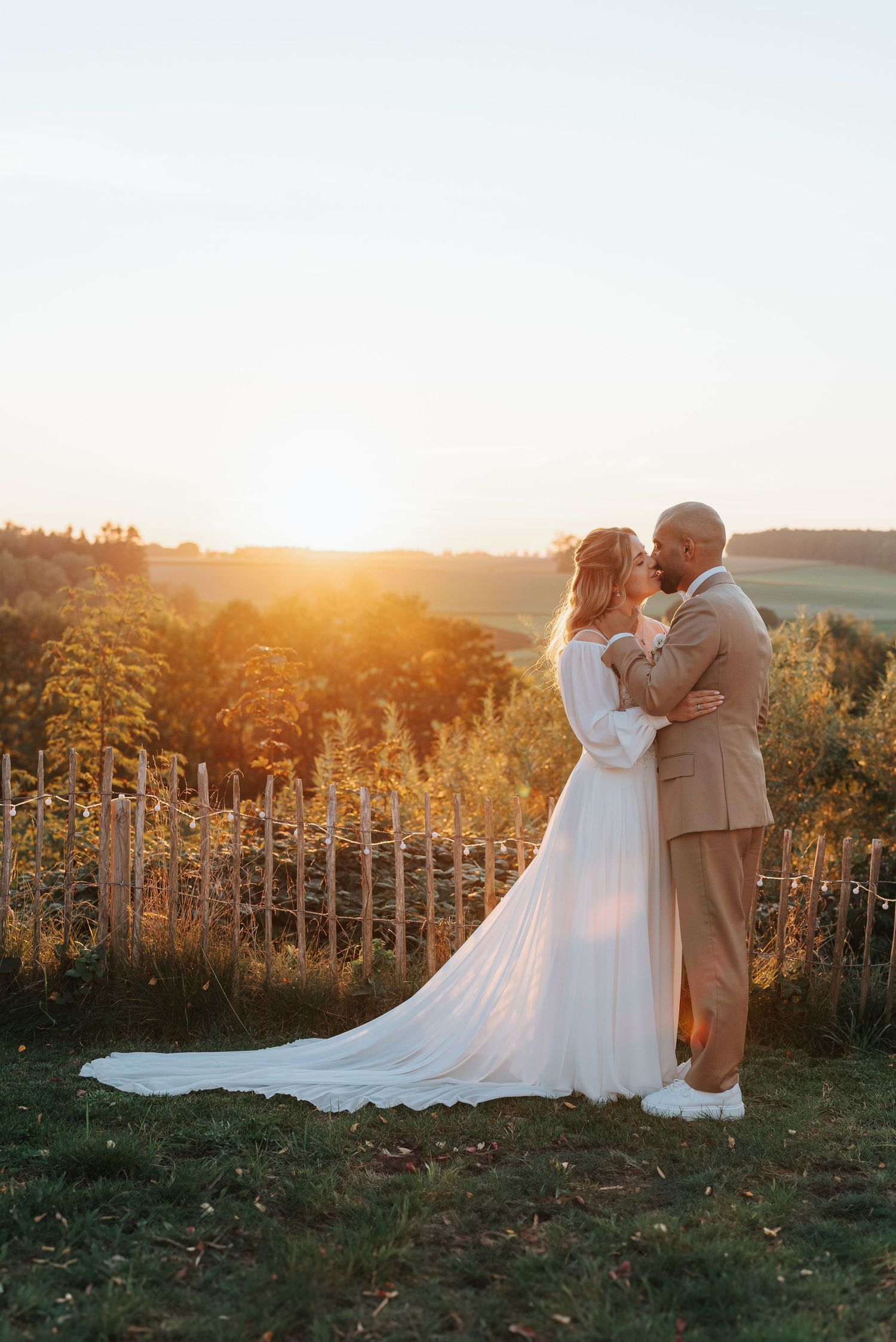 Elegant couple walking hand in hand on a countryside path.