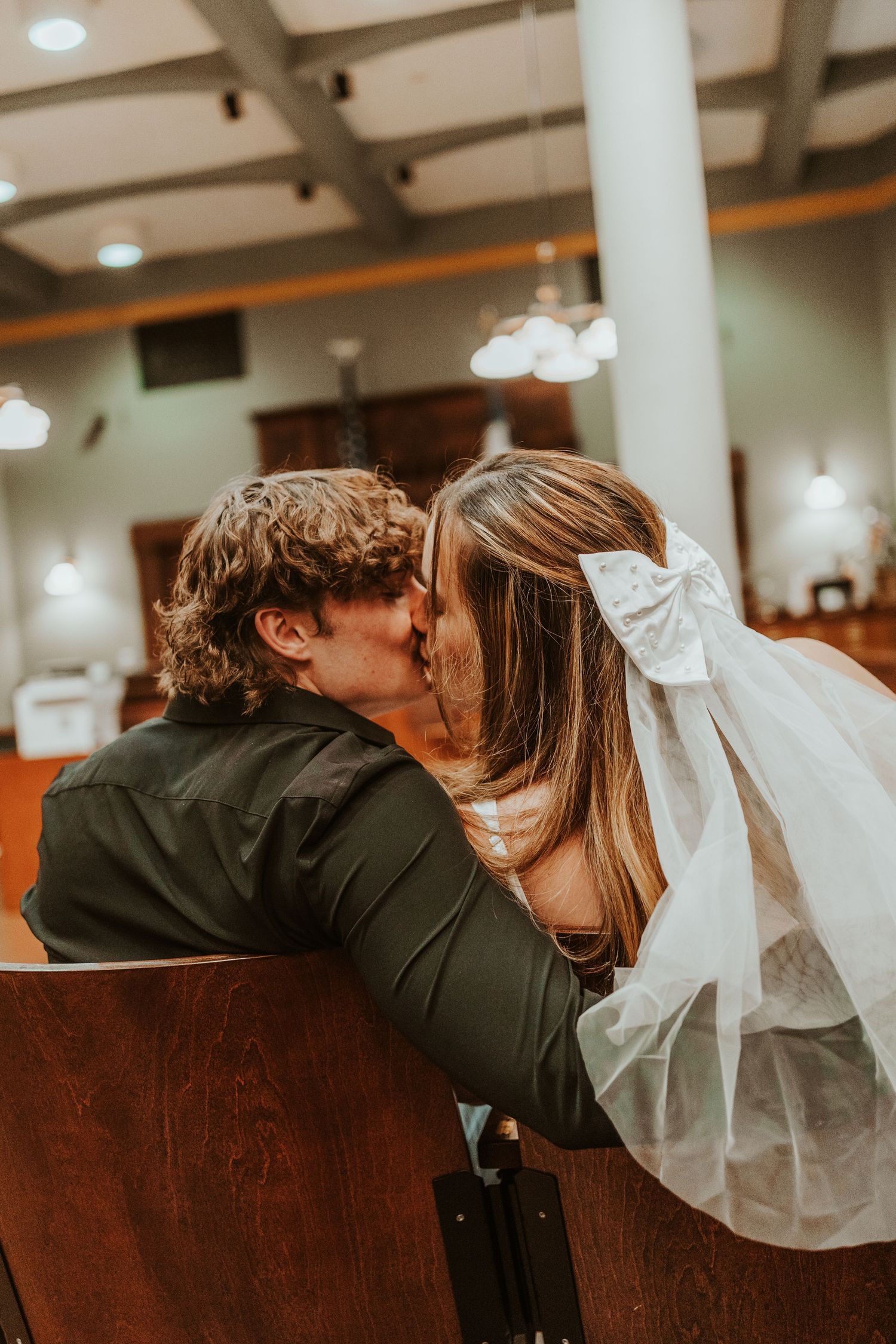 Intimate moment captured in an indoor setting with soft lighting.