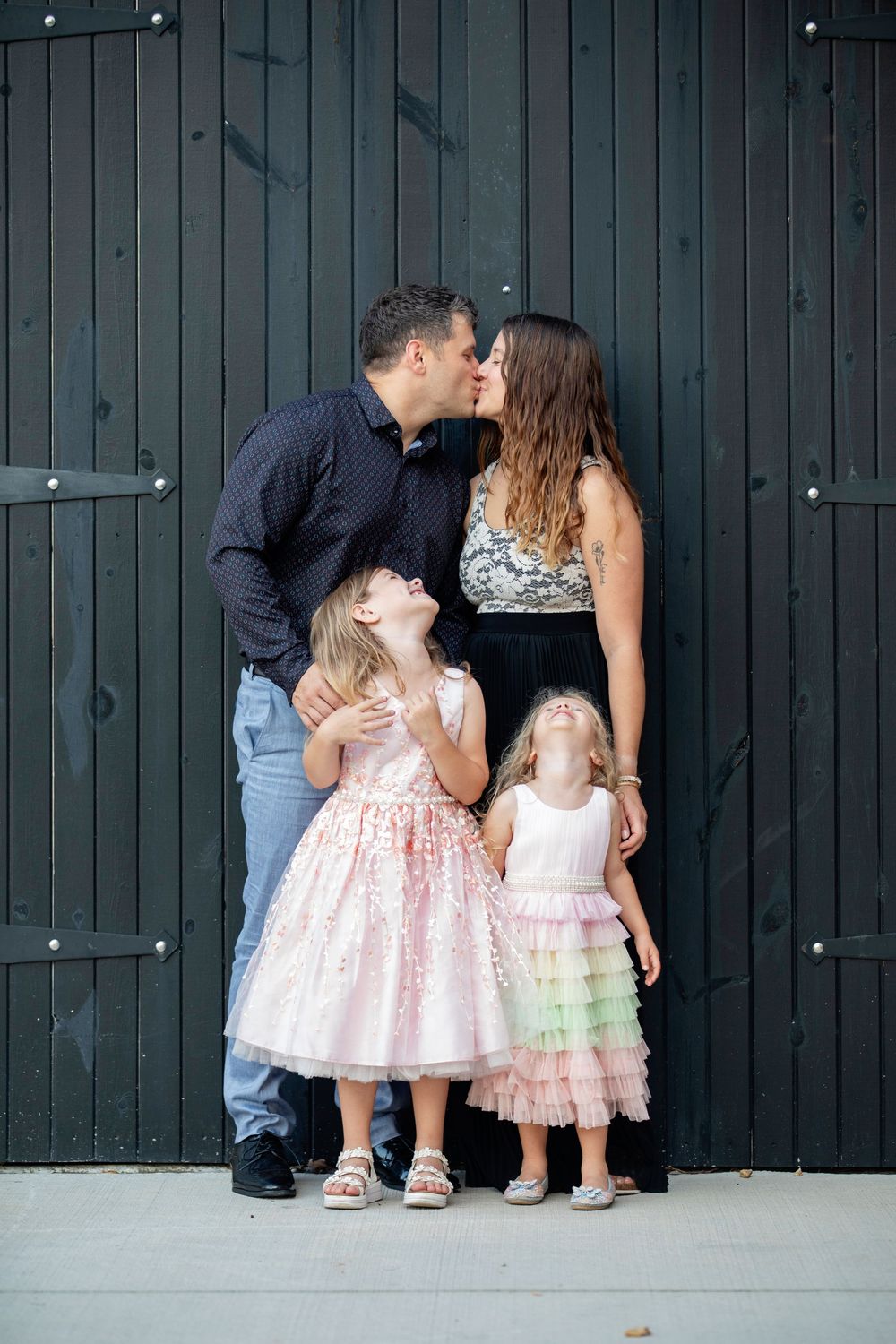 Downers Grove Family Photography photo of parents kissing while kids giggle by Julie Chen Photography