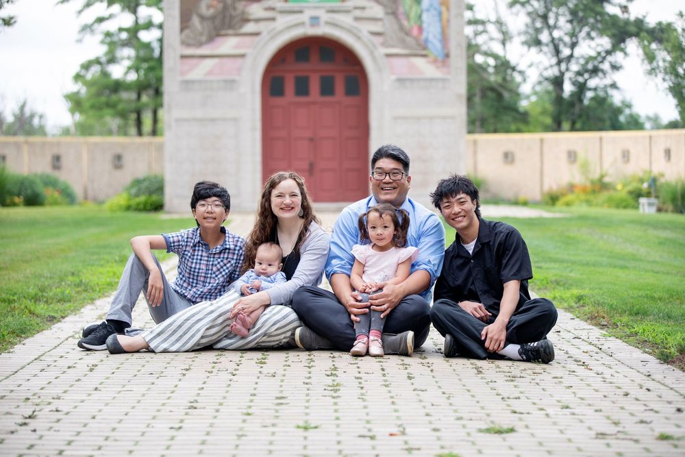 Downers Grove Family Photography photo of family smiling near chapel at Mayslake Peabody Estate Oak Brook Illinois by Julie Chen Photography