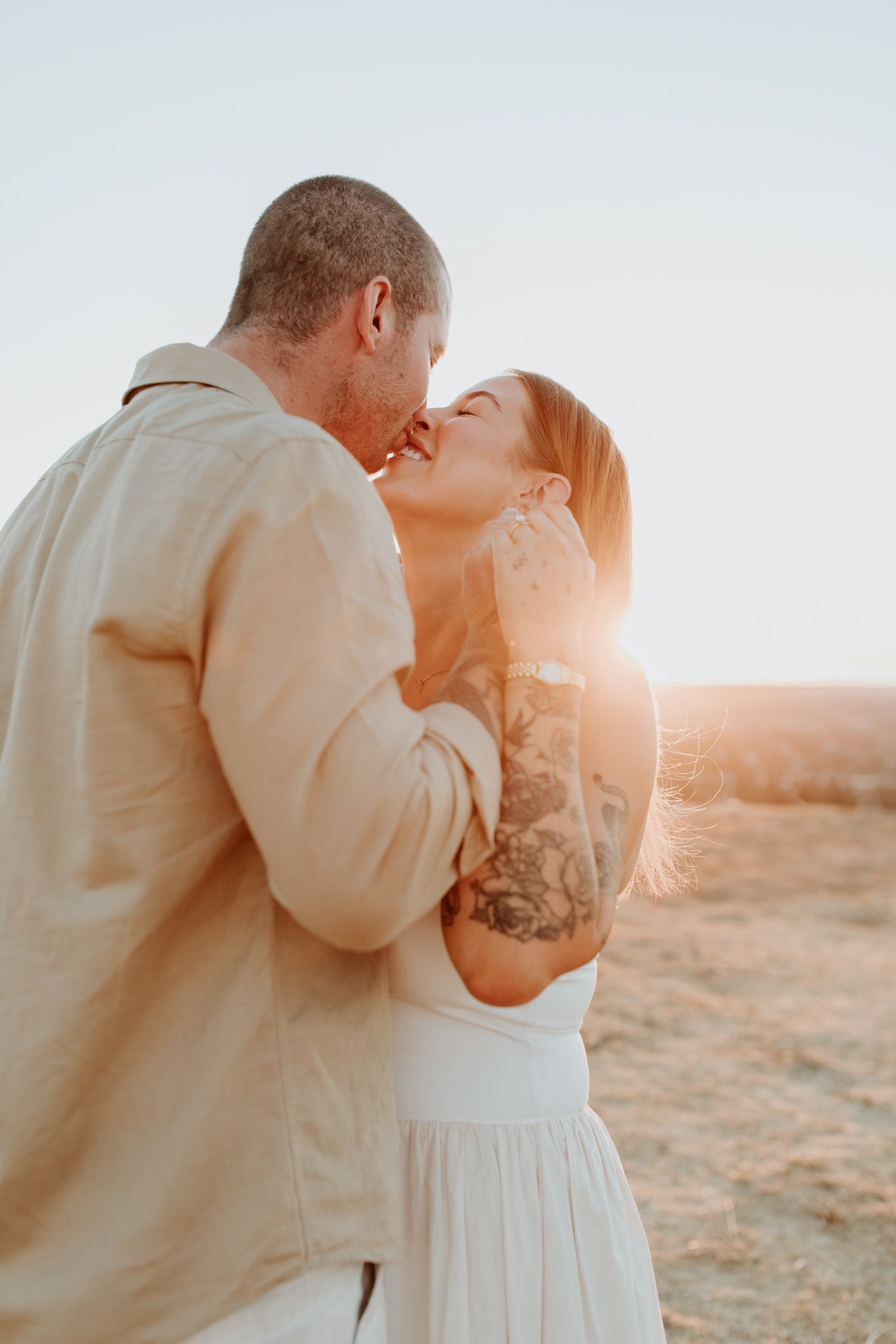 Lauren Lunn Photography: couple sharing an intimate moment during golden hour outdoors at Mt Osmond in Adelaide after getting engaged.
