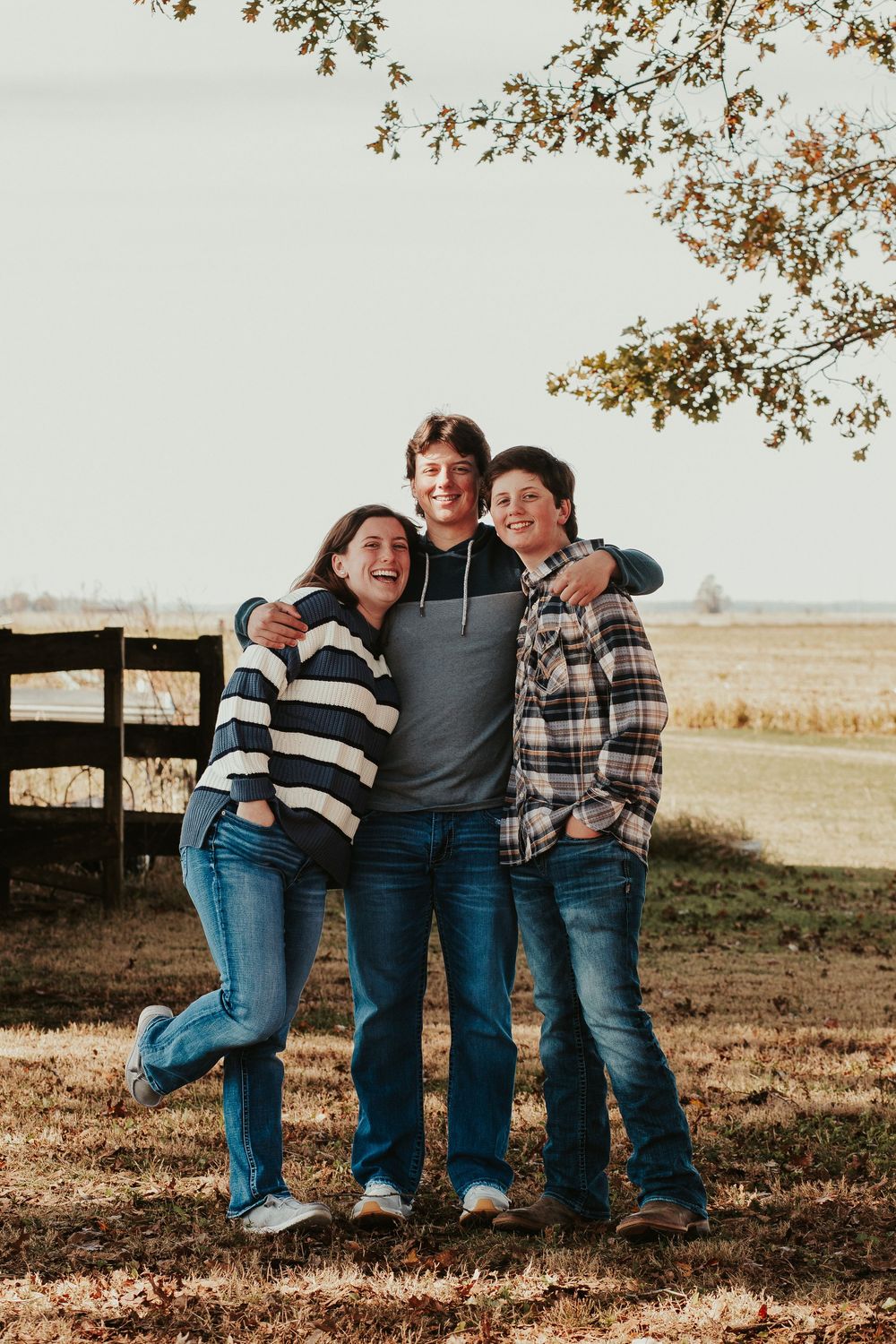siblings hugging in a yard