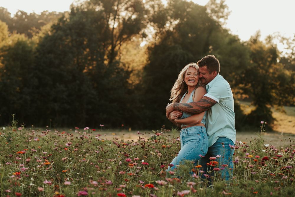 couple hugging in a field