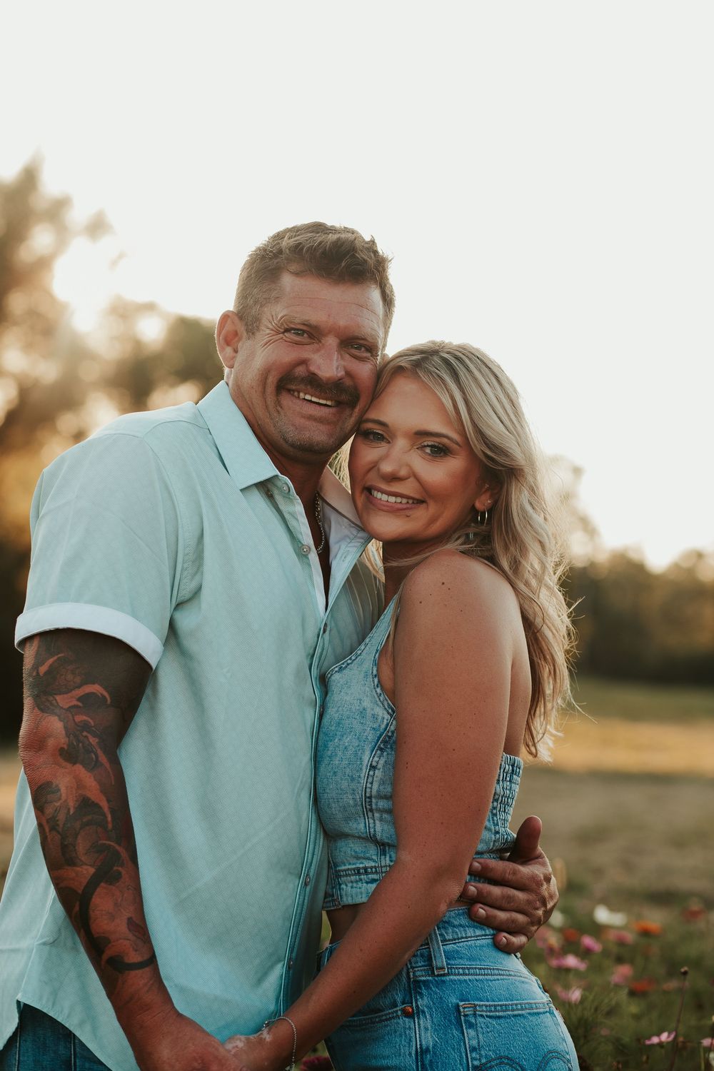 couple hugging in a field