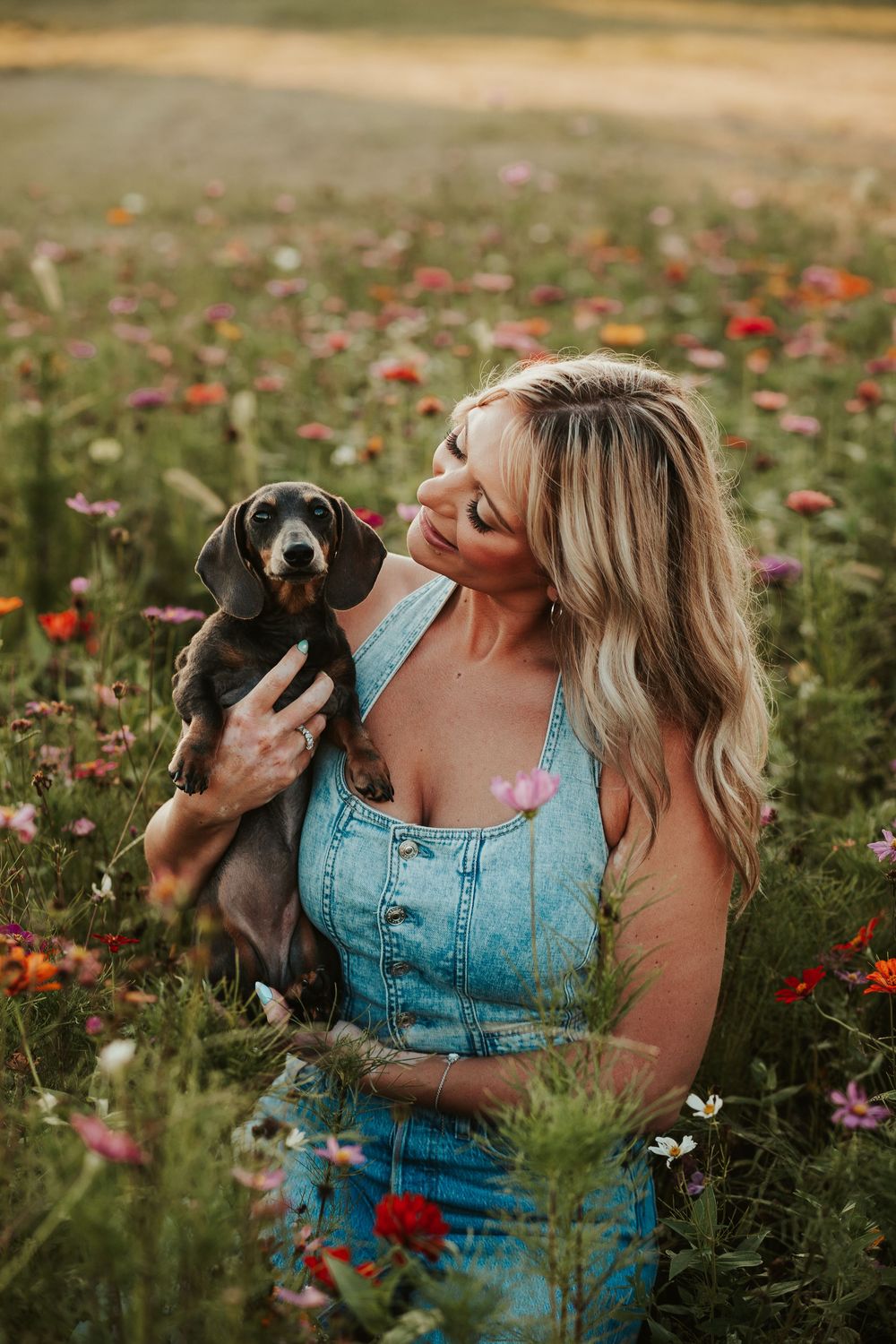 girl and her puppy in a flower field