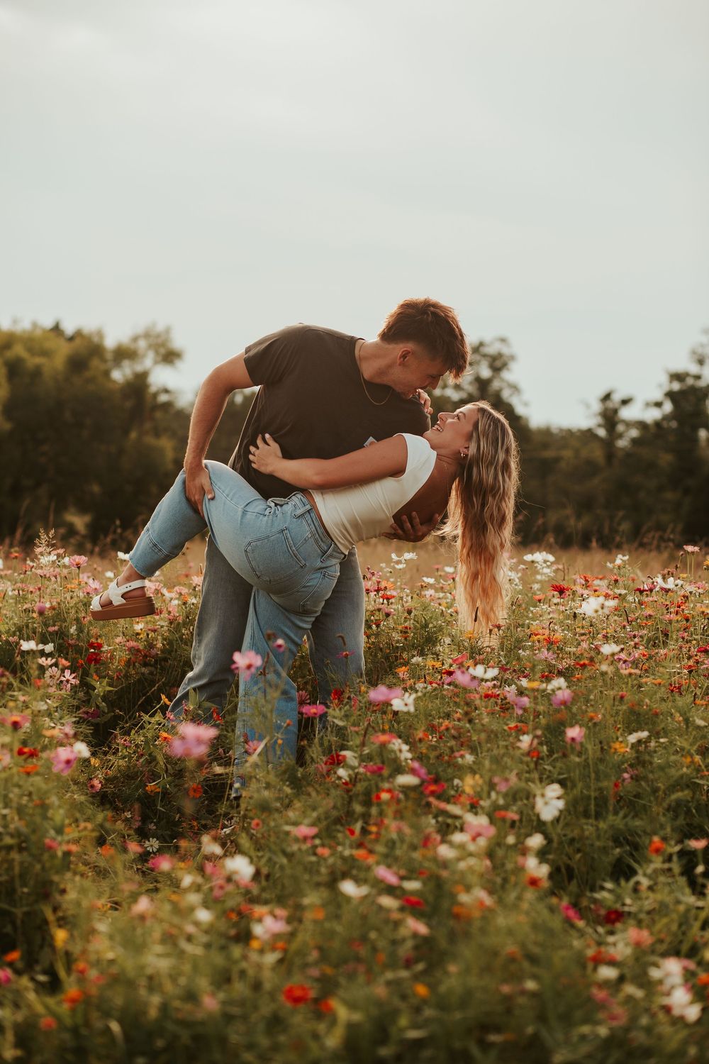 couple kissing in a flower field