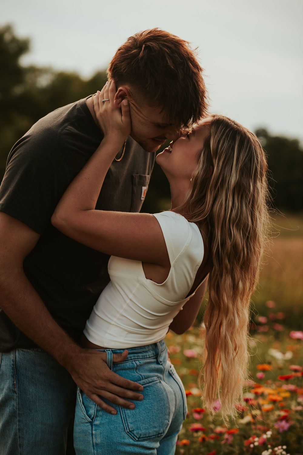 couple kissing in a flower field