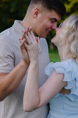A romantic sequence of a couple sharing tender moments outdoors in light colored clothing.