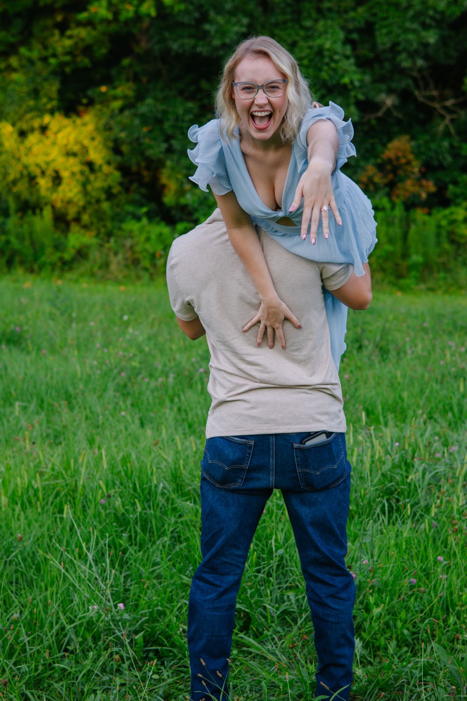 Playful piggyback ride sequence in a grassy field with natural lighting.