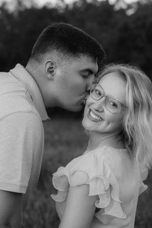 Black and white series showing a romantic couple embracing in soft natural light.