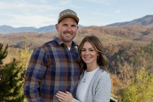 Couple shares happy moment together on scenic mountain overlook.