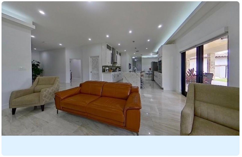 An Interactive 3D Floor Plan. Modern living room interior design showcases white walls with gloss finish and a vibrant orange leather sofa.