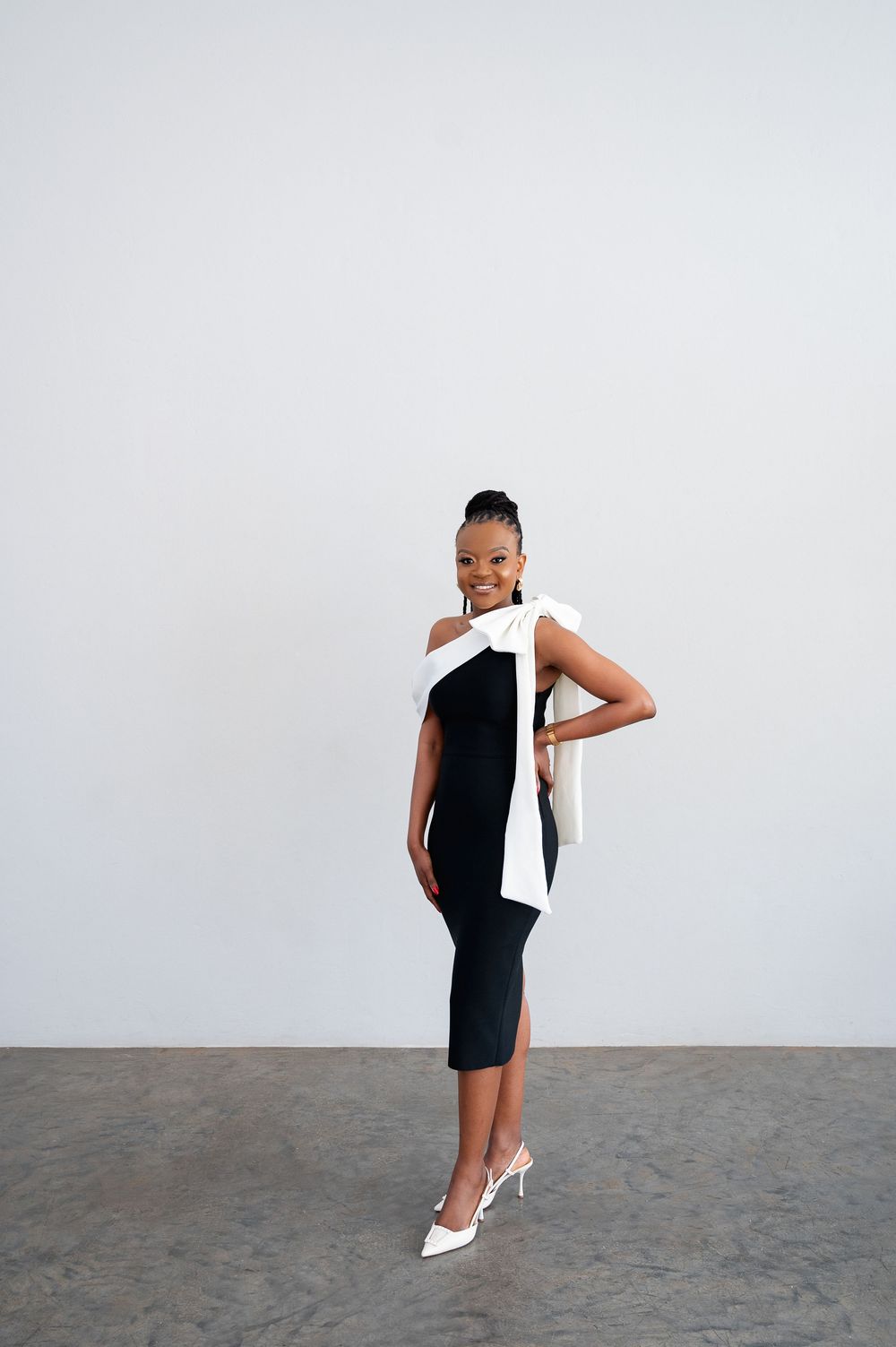 A person in a sleeveless black dress poses dynamically in a series of editorial style photos against a white backdrop.