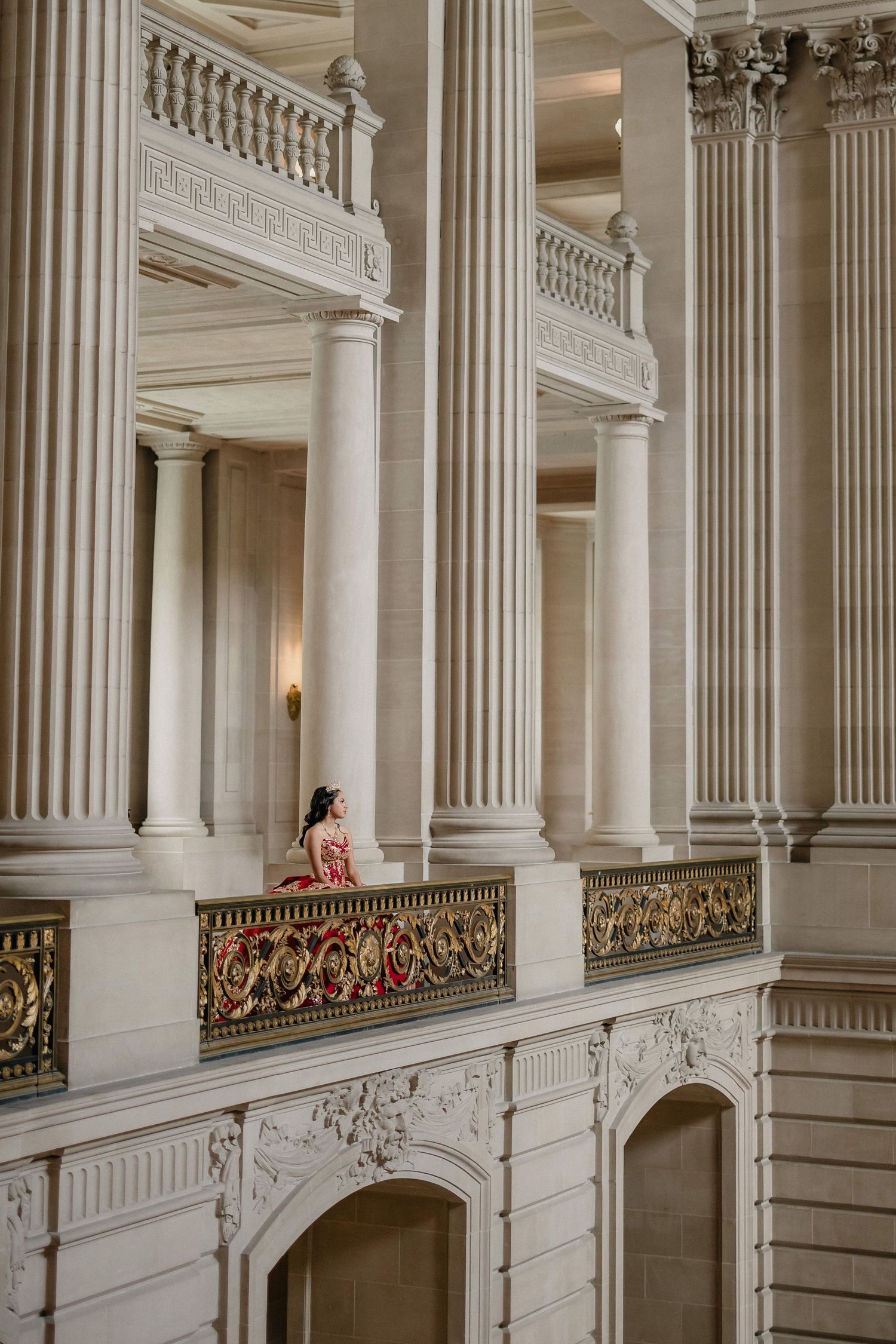 Classical white marble colonnade with decorative balustrades and ornate architectural details.