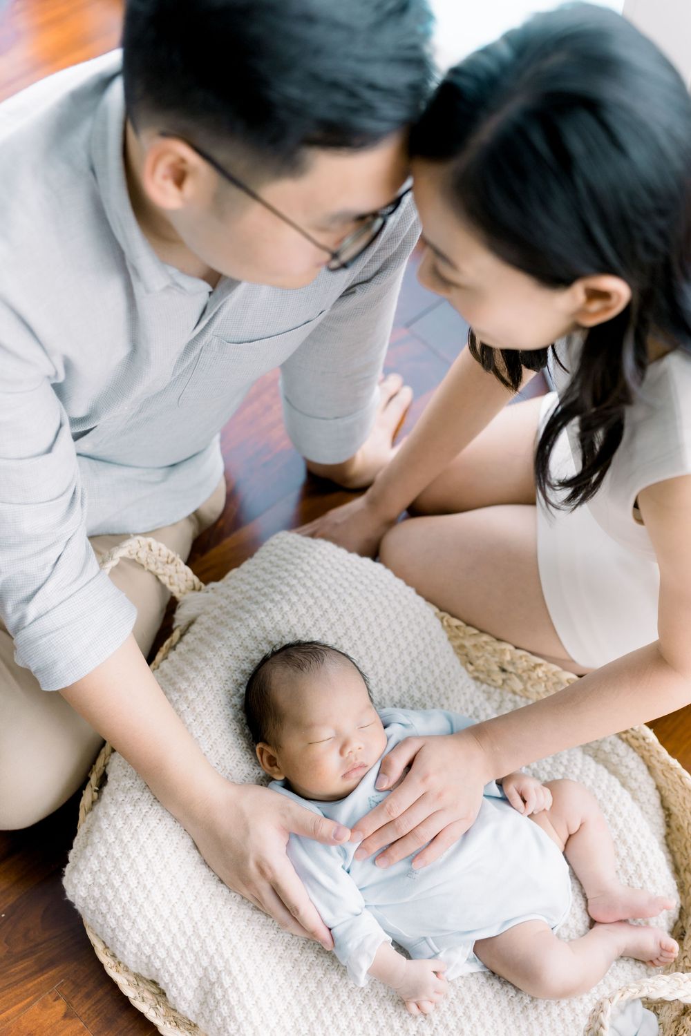 Baby massage therapy sequence showing gentle techniques being performed on an infant lying on a soft blanket.