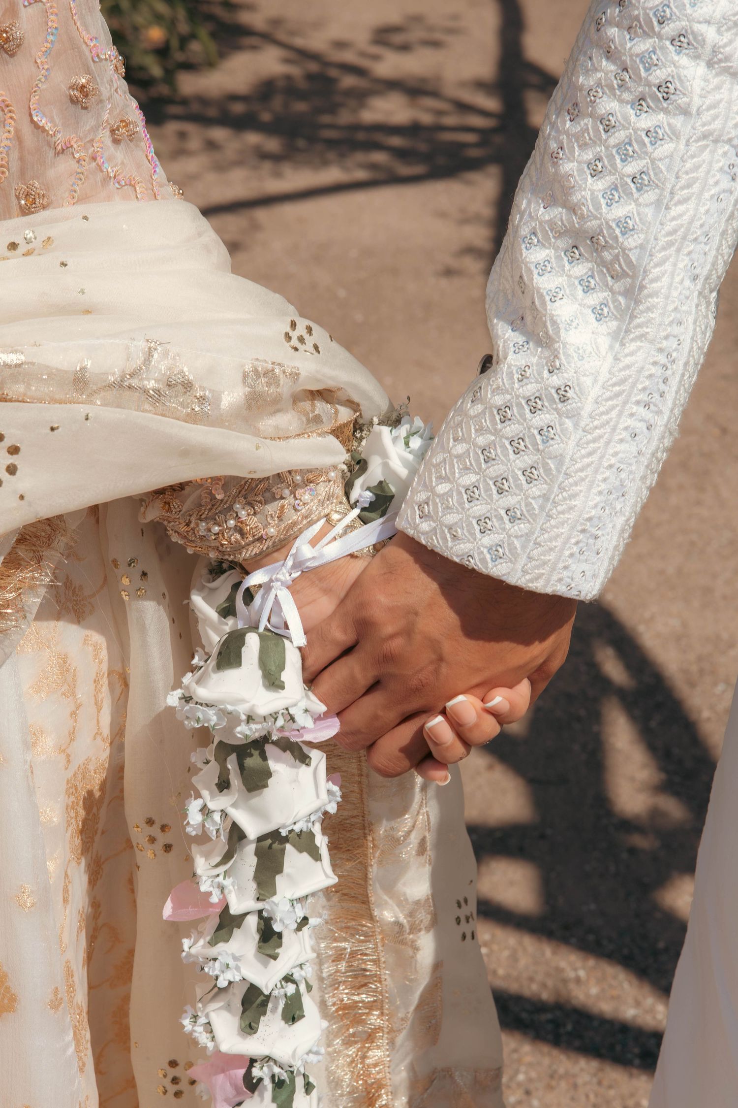 Delicate white lace sleeves and floral decorations in a wedding setting.
