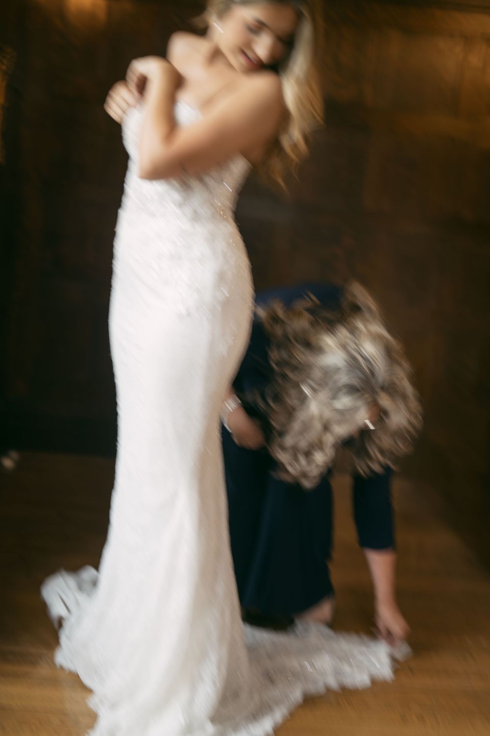 Blurred motion shot of people dancing at a wedding celebration.
