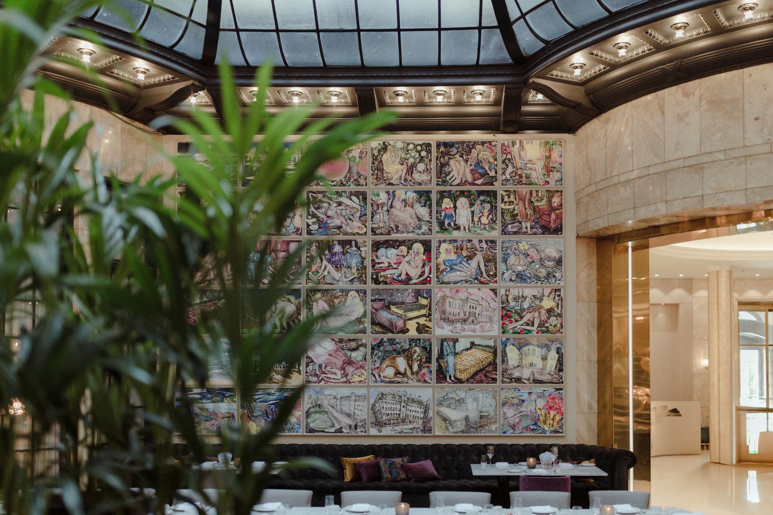 Modern event space with geometric ceiling design and colorful tiled wall details.
