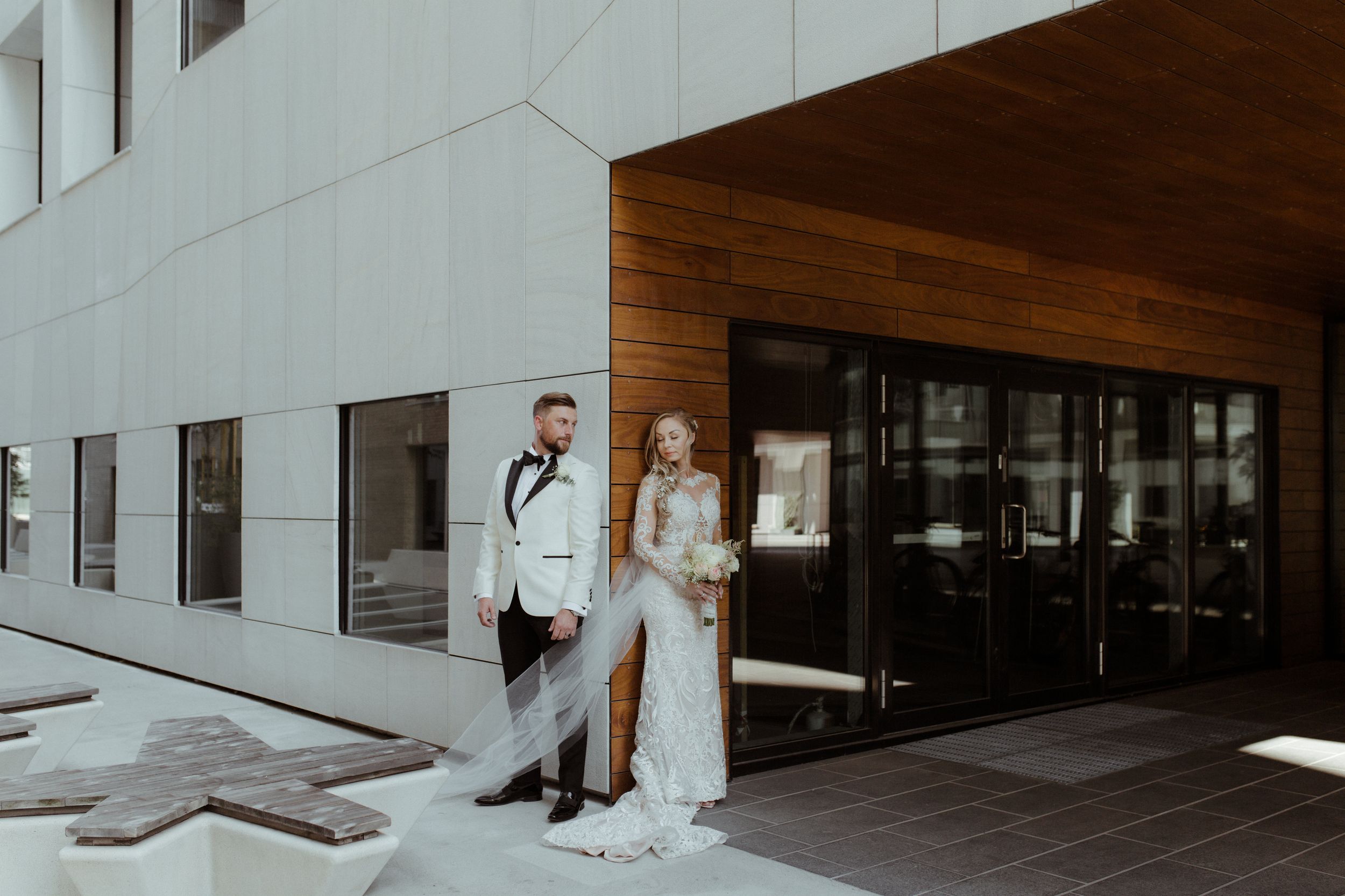 Modern wedding venue interior with sleek white walls and wooden accents.