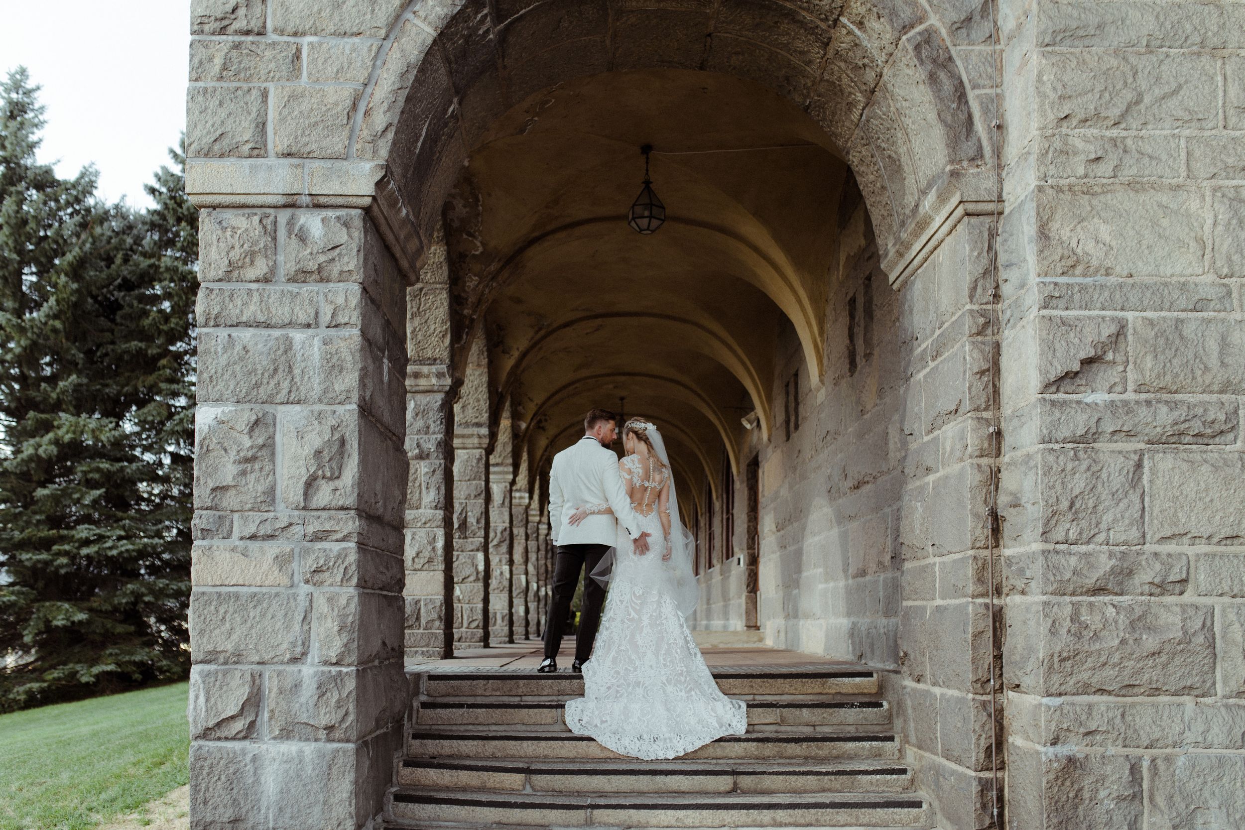Stone archway corridor with natural light streaming through the classical architectural elements.