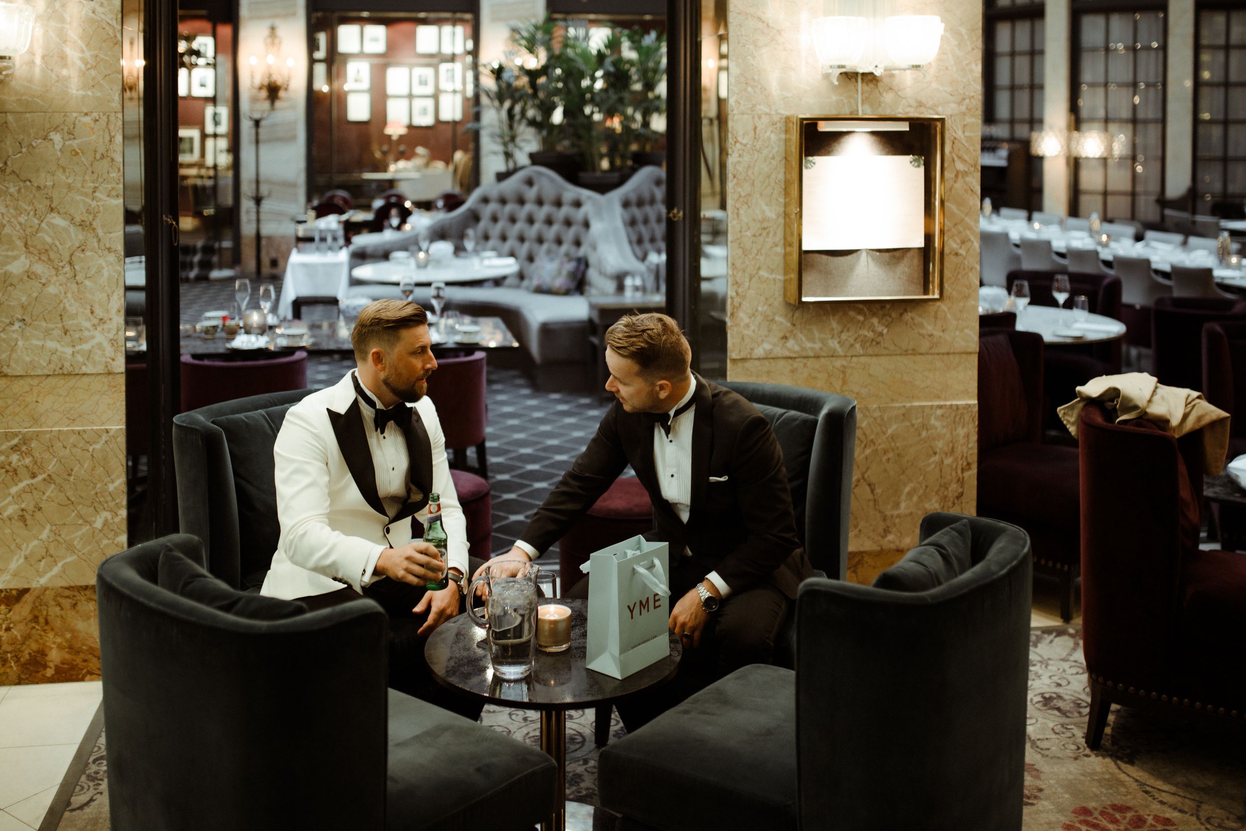 Modern hotel lobby lounge area with leather chairs and warm lighting creating an intimate atmosphere.