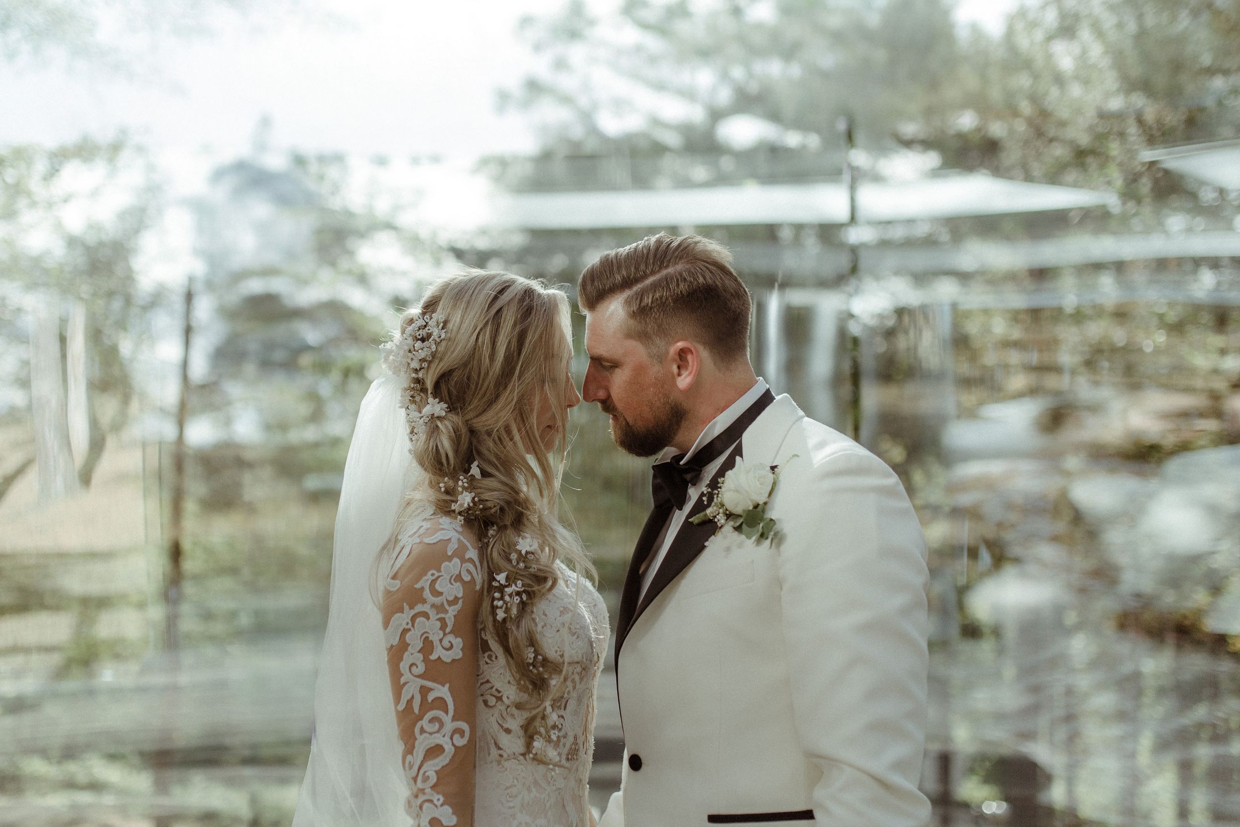 Ethereal wedding portraits with soft dreamy lighting in outdoor setting.