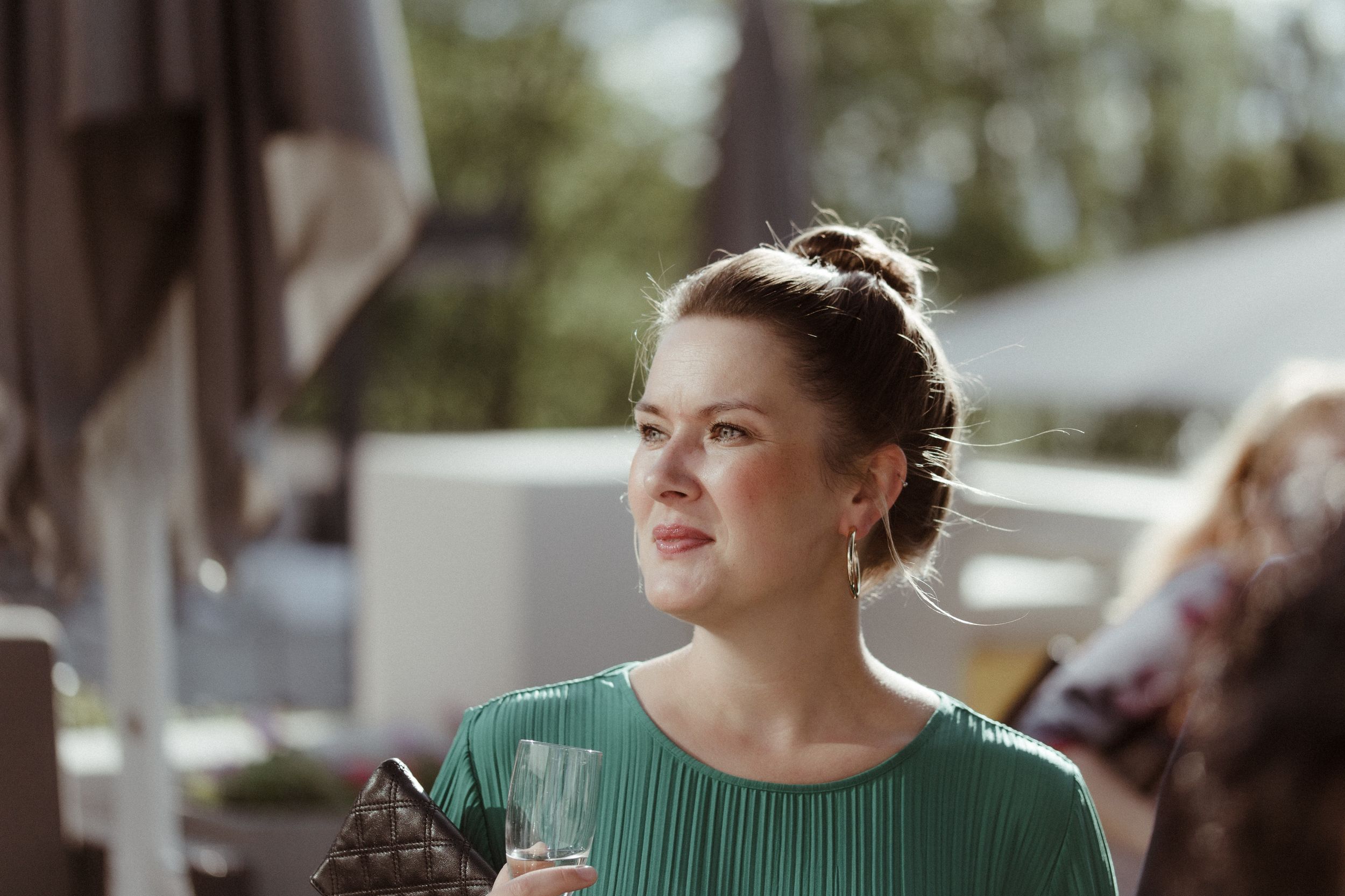 Wedding guests enjoying a sunny outdoor celebration in casual summer attire.