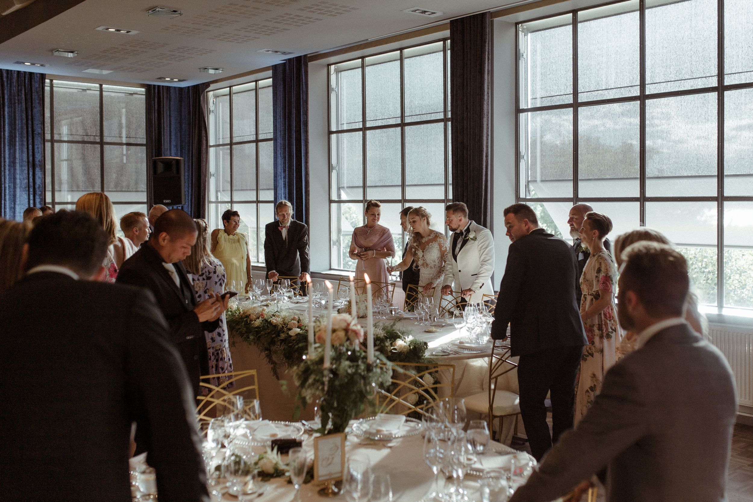 Elegant wedding reception venue with panoramic windows and tables set for dining.