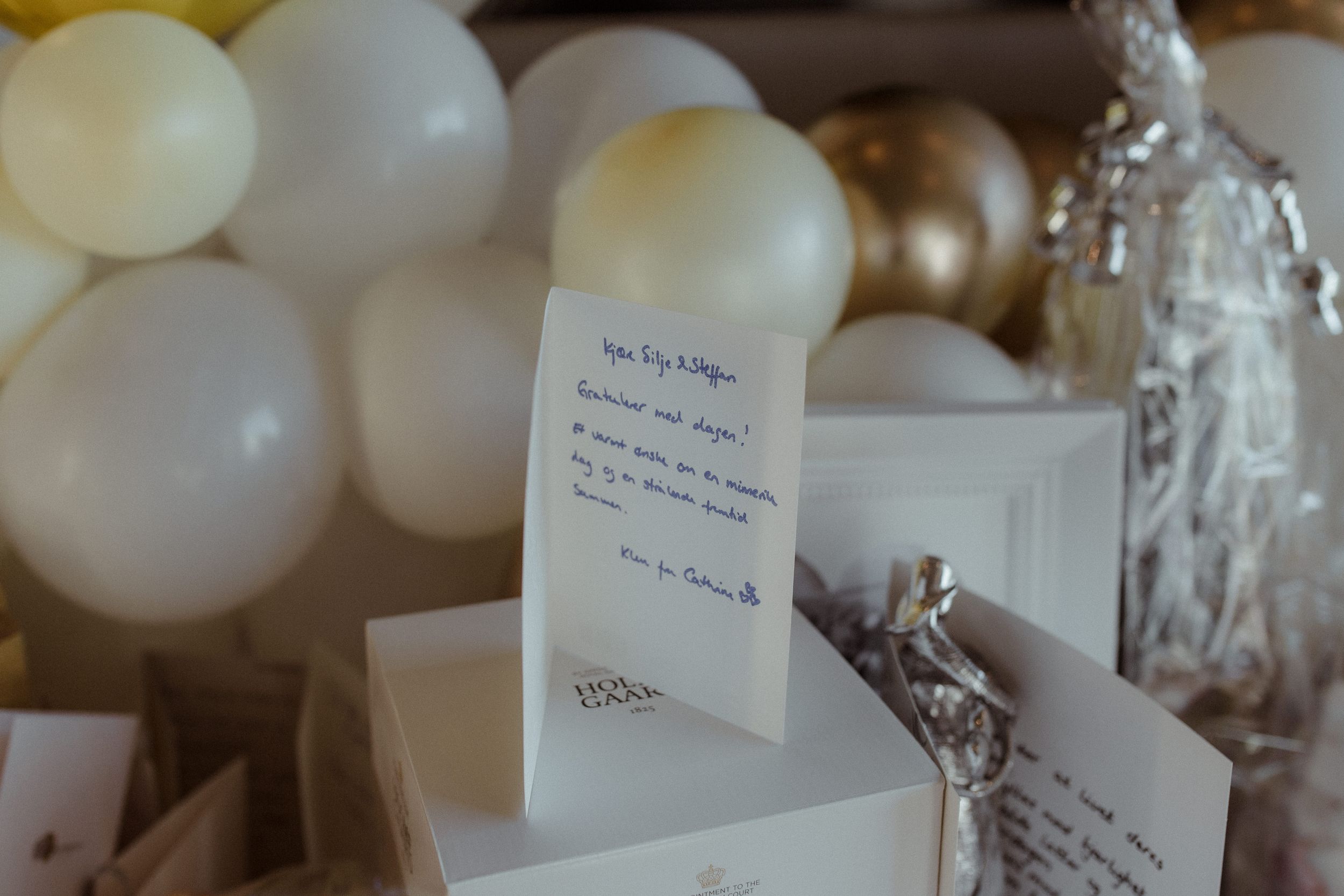 Elegant table settings with name cards and white floral arrangements at a formal event.