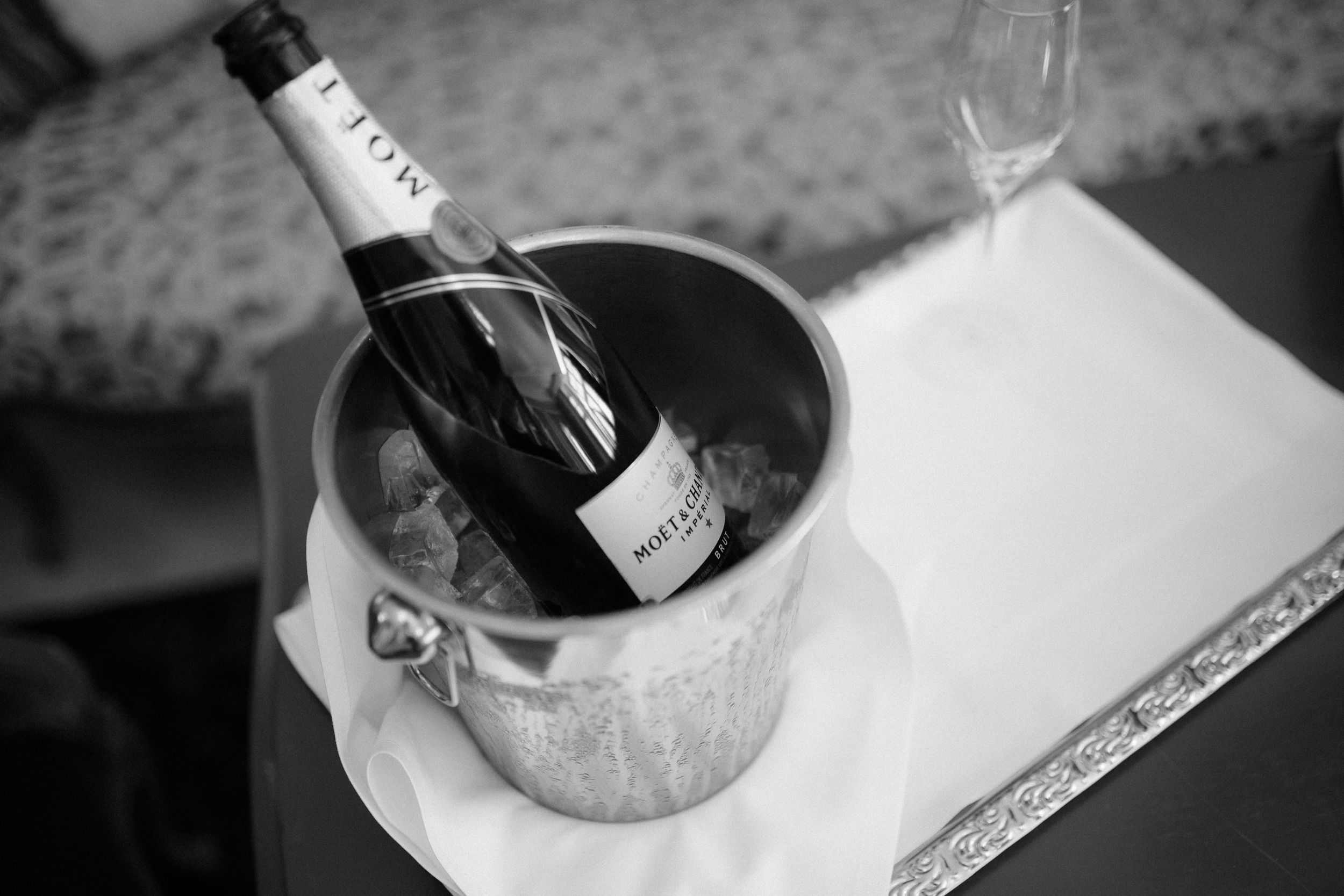 Black and white champagne pouring into glass creating elegant bubbles and swirls.